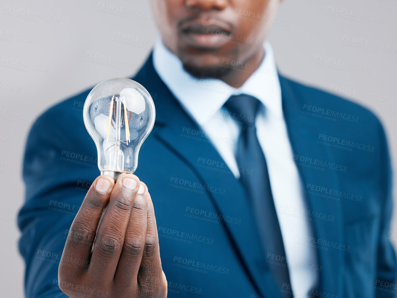 Buy stock photo Energy, hand and businessman with light bulb for idea, knowledge or inspiration for corporate business strategy. Electricity, lightbulb and black man with creative solution, innovation or closeup