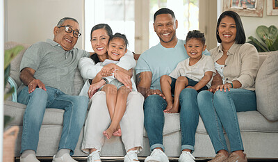 Buy stock photo Shot of a happy family sitting on the sofa at home and bonding