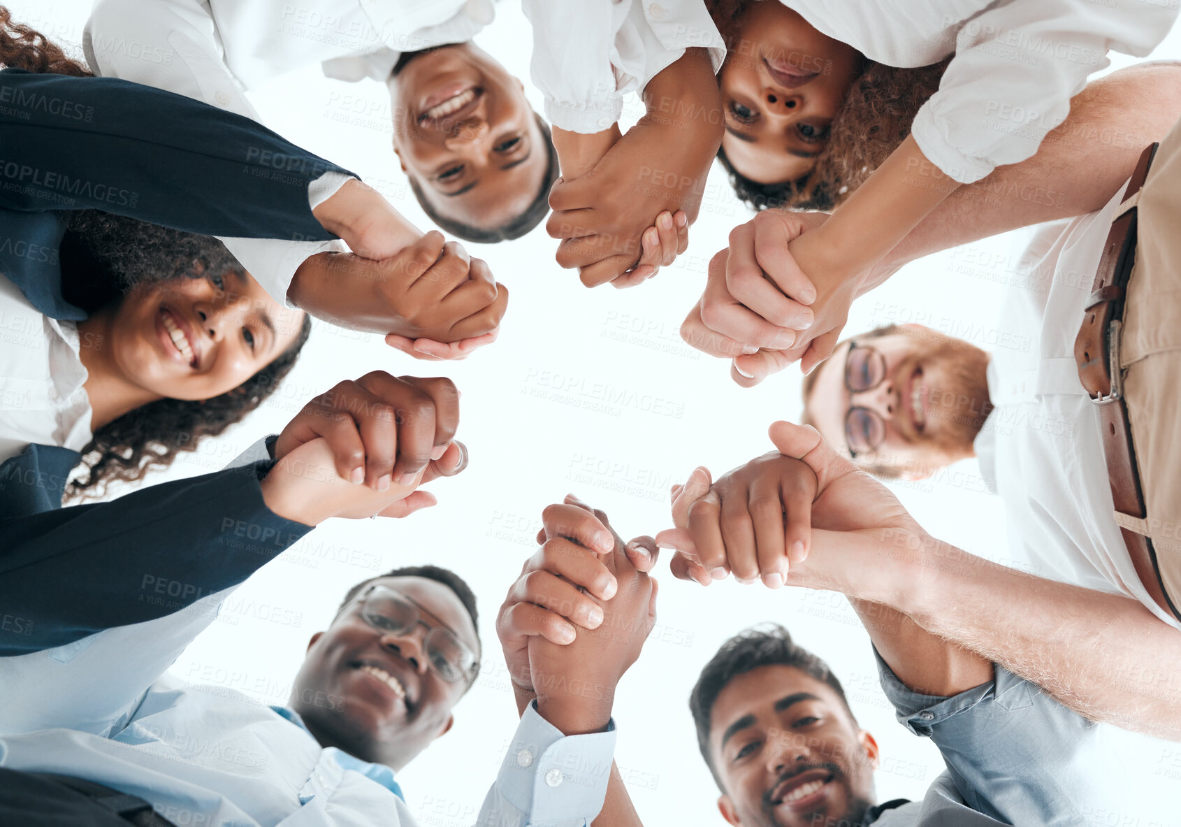 Buy stock photo Shot of a group of businesspeople holding hands in an office at work