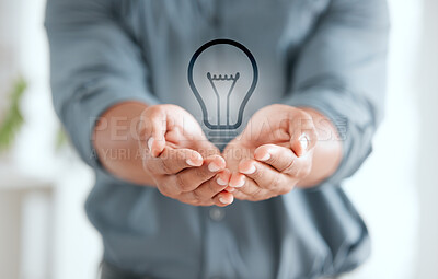 Buy stock photo Shot of an unrecognizable businessperson holding out their hands with a lightbulb placed in it at work