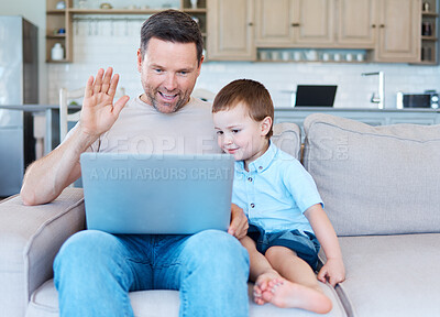 Buy stock photo Shot of a father and son using a laptop for a videocall at home