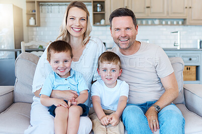 Buy stock photo Shot of a family sitting on the couch at home