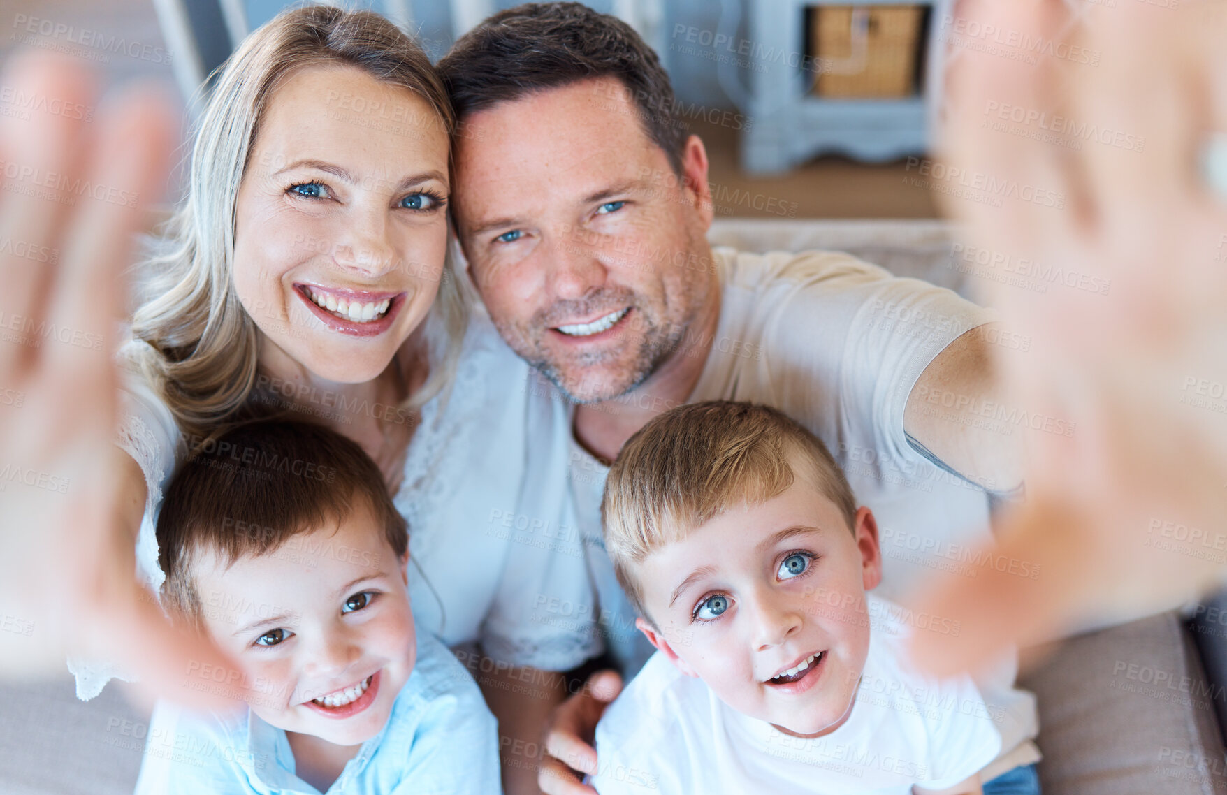 Buy stock photo Shot of a family sitting on the couch and taking a selfie at home