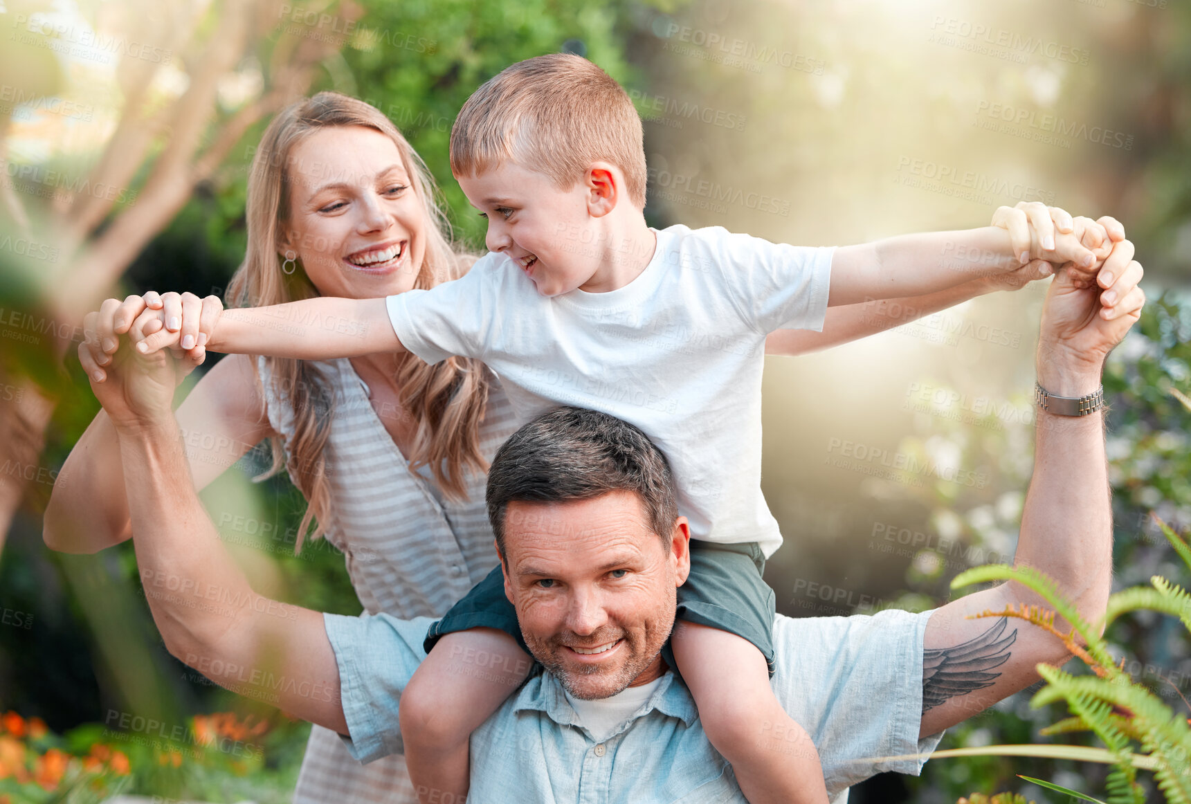 Buy stock photo Child, shoulder and happy family in outside together, parents and boy in garden for bonding on weekend break. Summer, love and smile for care on holiday, nature trees and support or playful backyard