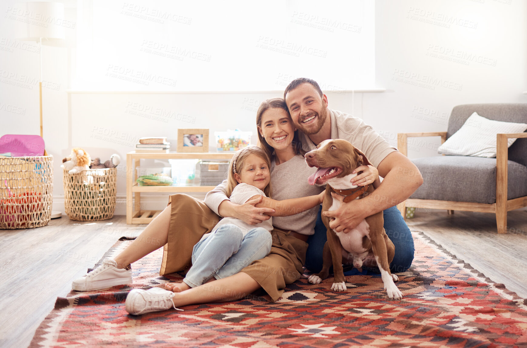 Buy stock photo Happy family, girl and portrait with dog in living room for quality time, love and care together at home. Mother, father and parents of child relax on carpet floor with pet pitbull, hug and happiness