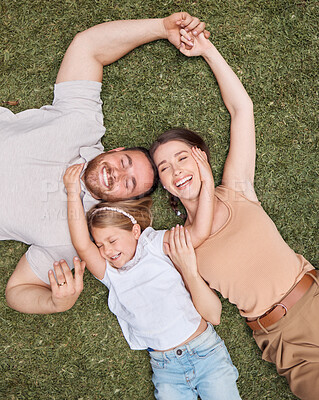 Buy stock photo Top view, smile and family on the grass, bonding and relationship with fun, happiness and loving together. Parents, mother and father with a girl, daughter and female kid in the backyard and cheerful