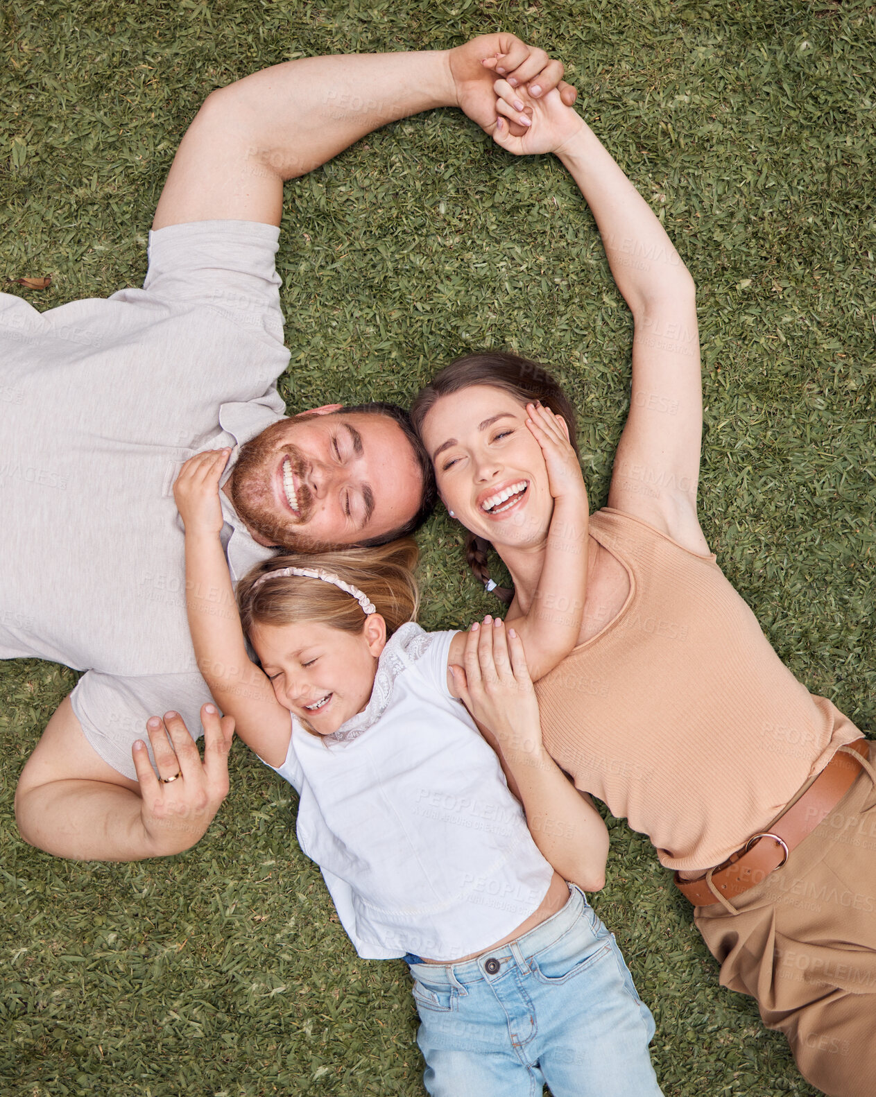 Buy stock photo Top view, smile and family on the grass, bonding and relationship with fun, happiness and loving together. Parents, mother and father with a girl, daughter and female kid in the backyard and cheerful