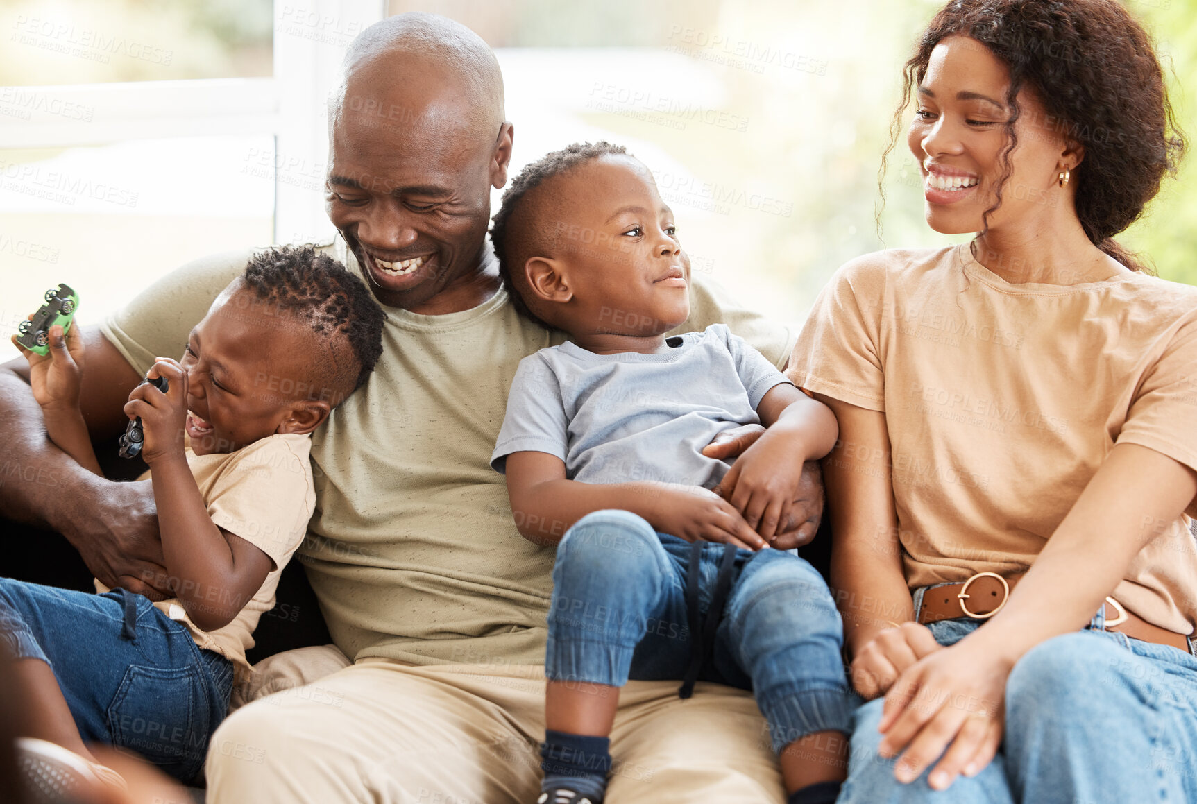 Buy stock photo Black family, hug and laughing to relax in home, childcare and together for games in living room. Parents, children and toys for playing in lounge, support and care for kids or love and happiness