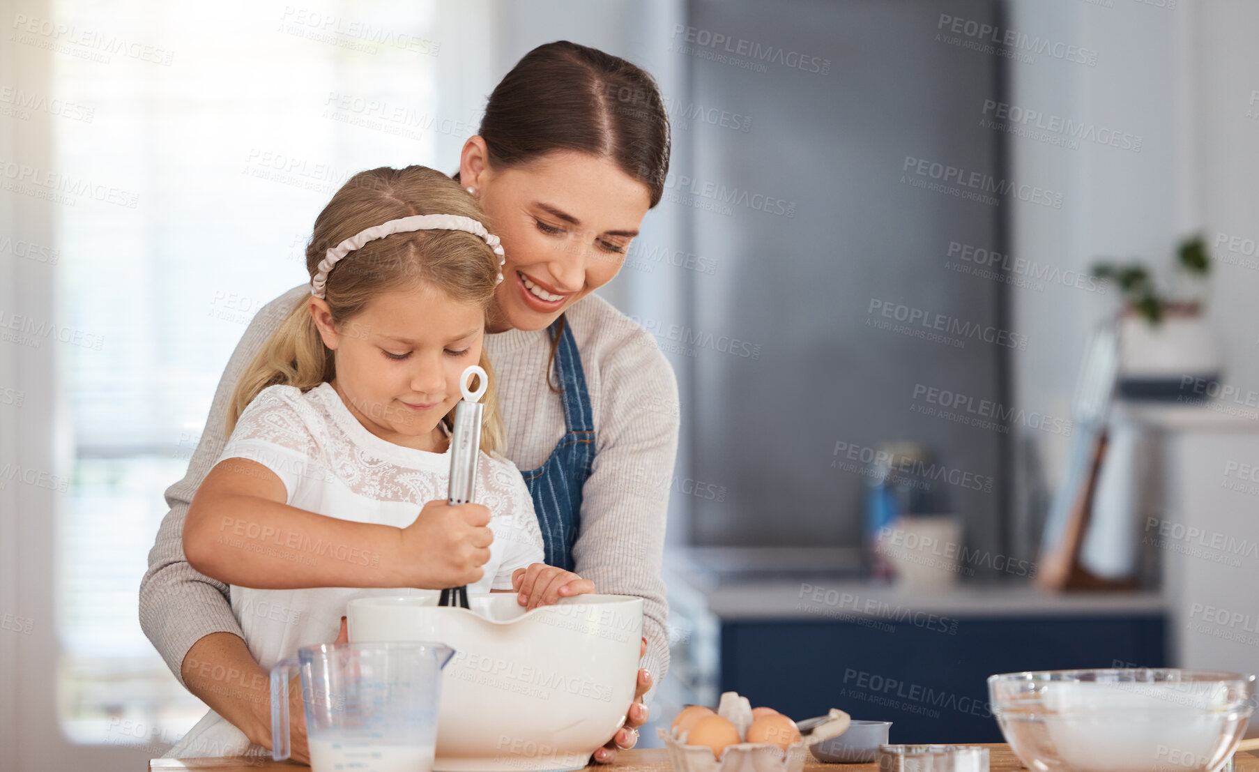 Buy stock photo Woman, child and baking in house kitchen, family home and kid assisting for culinary skills or bonding together. Teaching, girl development and mixing ingredients, apartment and support with love