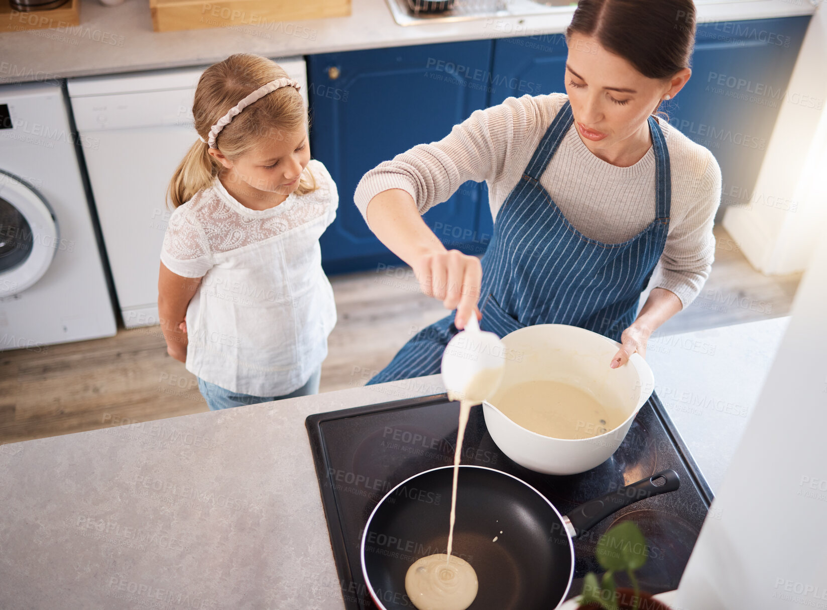 Buy stock photo Mother, girl and pancake on home stove, child and watching woman in kitchen with baking mixture in pan. Cooking, above and learning in apartment, bonding and weekend break with breakfast in house