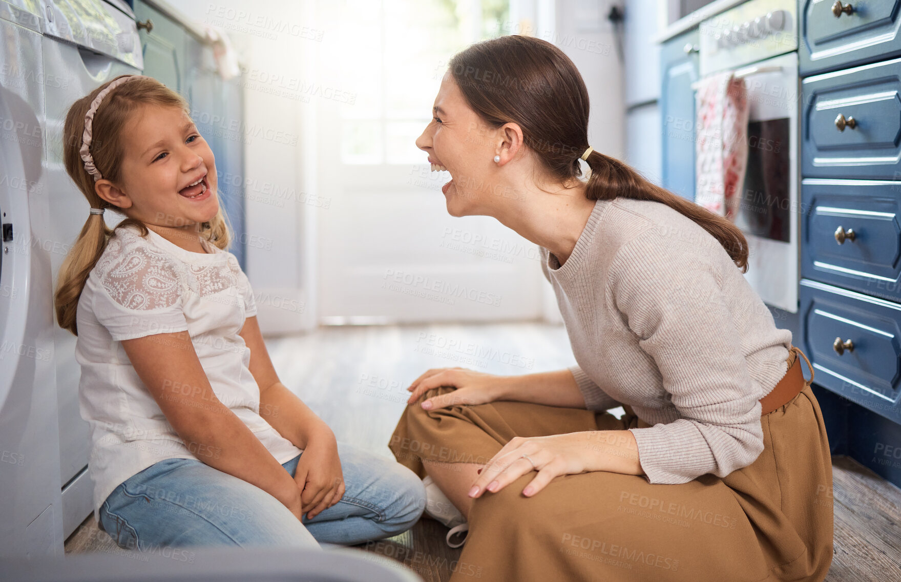 Buy stock photo Mom, daughter and laughing together on floor for bonding time, support and silly joke in home kitchen. Mother, girl child and happy discussion for love, maternal care and funny conversation on ground