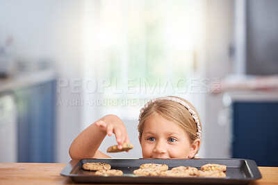 Buy stock photo Shot of an adorable little girl taking a cookie from a baking tray