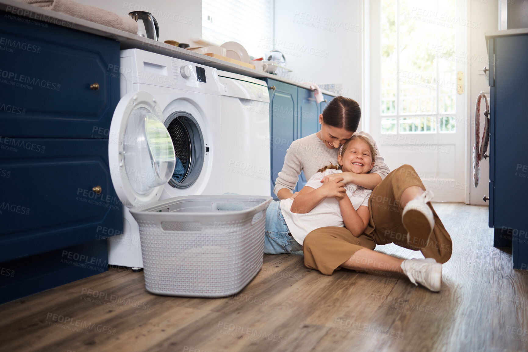 Buy stock photo Mother, girl and hug with washing machine for laundry, child and woman with clothing basket or playful on floor. Life skills, chores and home for bonding, routine and happy for domestic housework