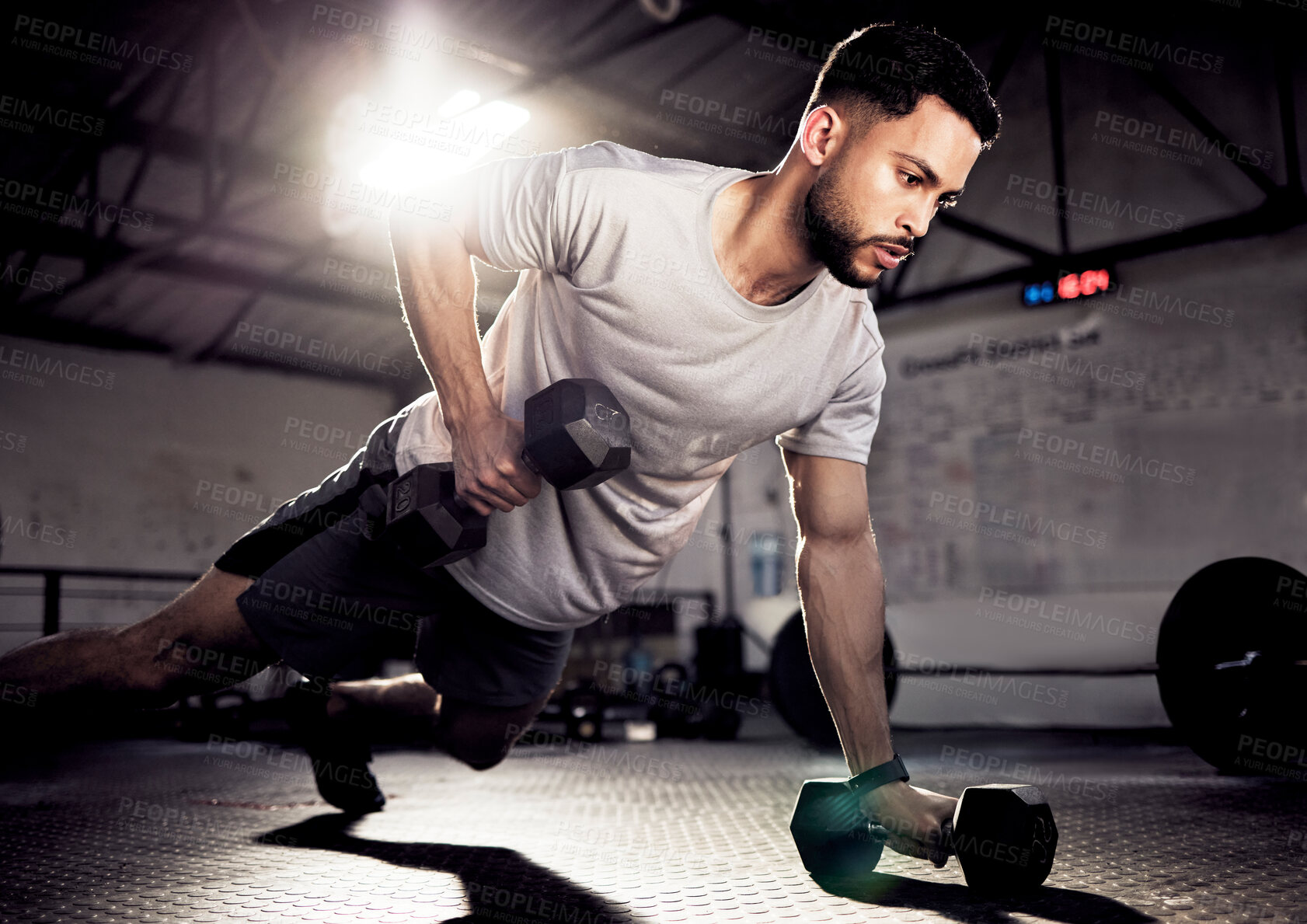 Buy stock photo Fitness, push up and man exercise with dumbbells at gym for training workout with focus. Serious male athlete or bodybuilder with weights for strong muscle, power or motivation for hard work on floor