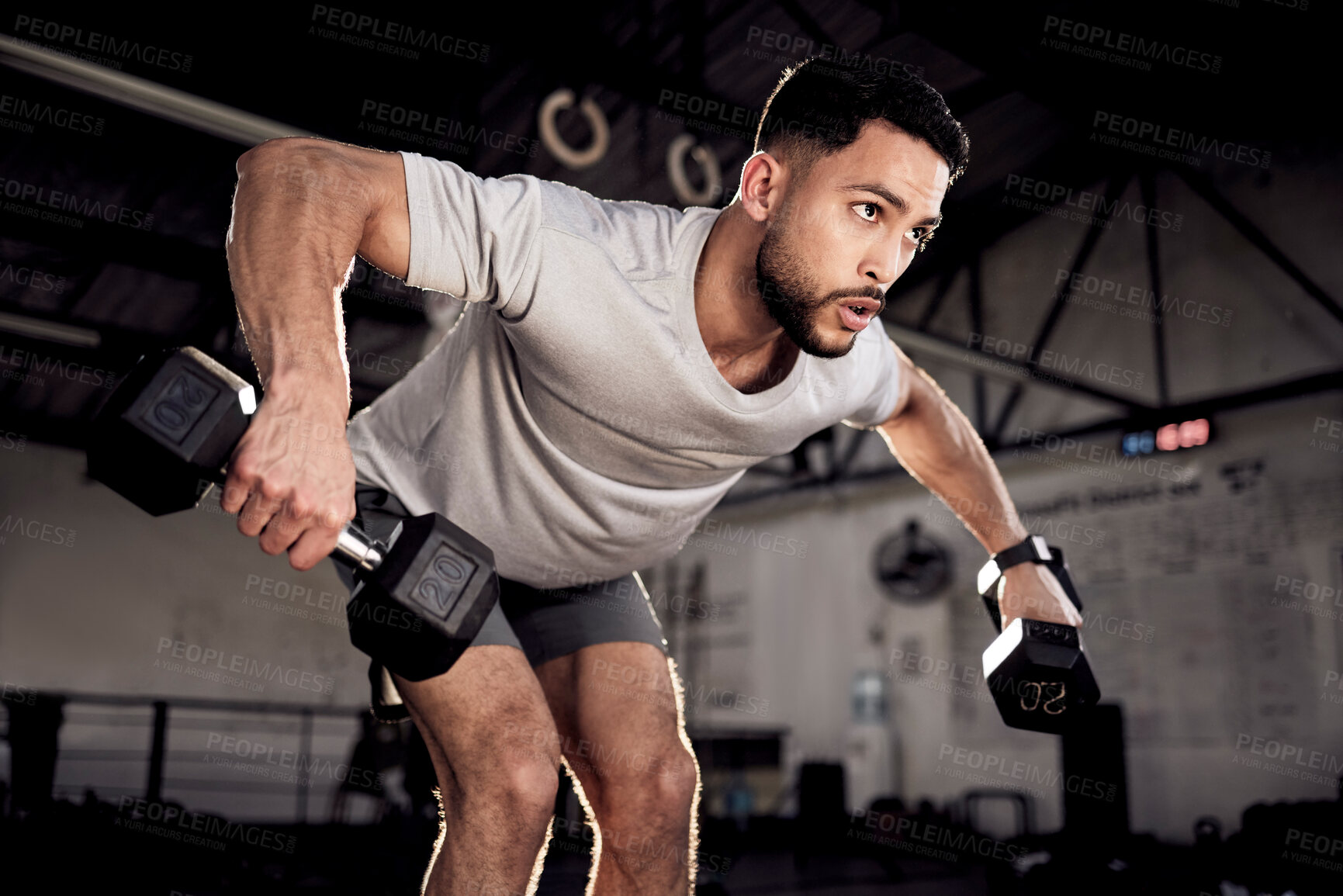 Buy stock photo Fitness, dumbbells and man exercise at gym for training workout with focus. Serious male athlete or bodybuilder with weights for strong muscle, power or motivation for hard work and bent over row