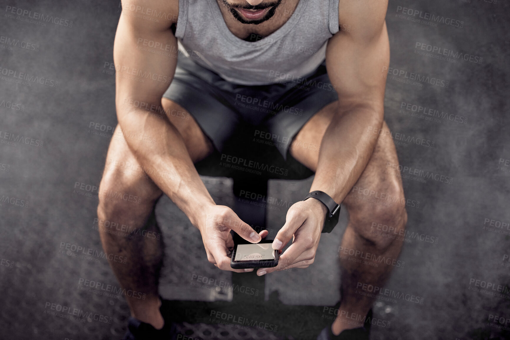 Buy stock photo Man, phone and app for workout in gym, tracking fitness and online research for exercise. Male person, above and athlete for health or wellness progress, social media and internet for conversation