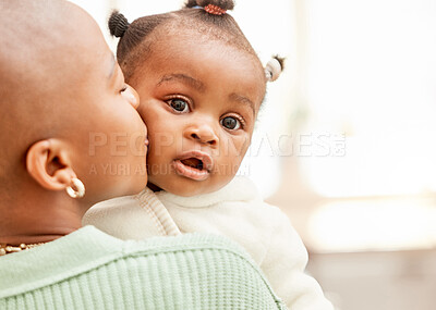 Buy stock photo Cropped shot of an unrecognizable young woman kissing her daughter on the cheek  in the kitchen at home