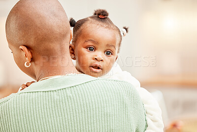 Buy stock photo Cropped shot of an unrecognizable young woman carrying her daughter in the kitchen at home