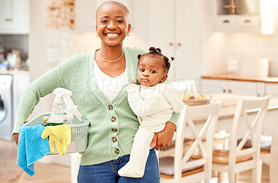 Buy stock photo Cropped portrait of an attractive young woman carrying her daugher while doing chores at home