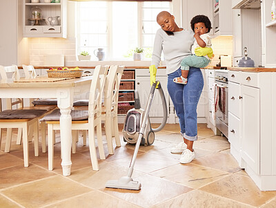 Buy stock photo Shot of a young mother on a call while vacuuming at home