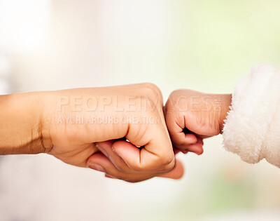 Buy stock photo Shot of a mother and baby fist bumping one another
