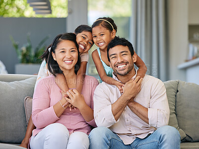 Buy stock photo Hug, asian family portrait and happy kids on sofa in living room for care, happiness and bonding. Love, parents and girl children on couch for relax, having fun or together with a smile in home