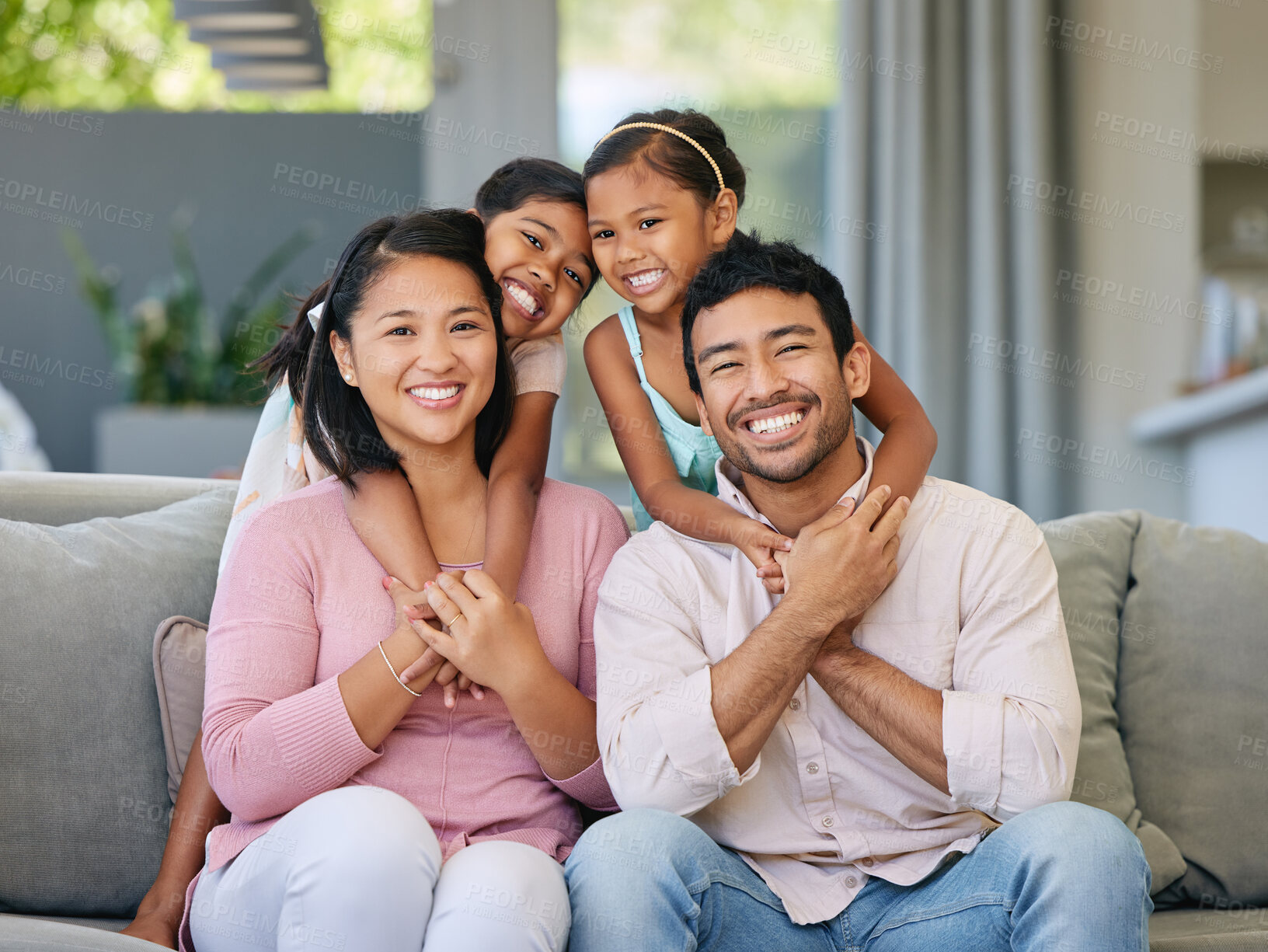 Buy stock photo Hug, asian family portrait and happy kids on sofa in living room for care, happiness and bonding. Love, parents and girl children on couch for relax, having fun or together with a smile in home