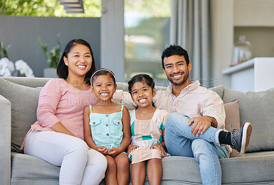 Buy stock photo Portrait, parents and kids on sofa with smile, bonding and relax together in living room on weekend. Mom, dad and girl children on couch with love, trust and support in modern home in Indonesia.
