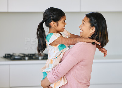 Buy stock photo Shot of a young mother holding her daughter