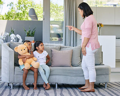 Buy stock photo Mother, pointing and scolding child in home, discipline and communication or strict parent in family house. Living room, girl and sofa for punishment or conflict and behaviour, upset and parenting