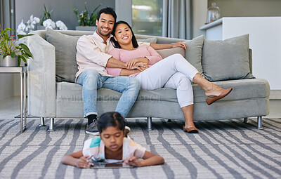 Buy stock photo Relax, parents and child with tablet in living room watching movie, film or show online at home. Happy, love and mother and father bonding on sofa with girl streaming with digital technology on floor