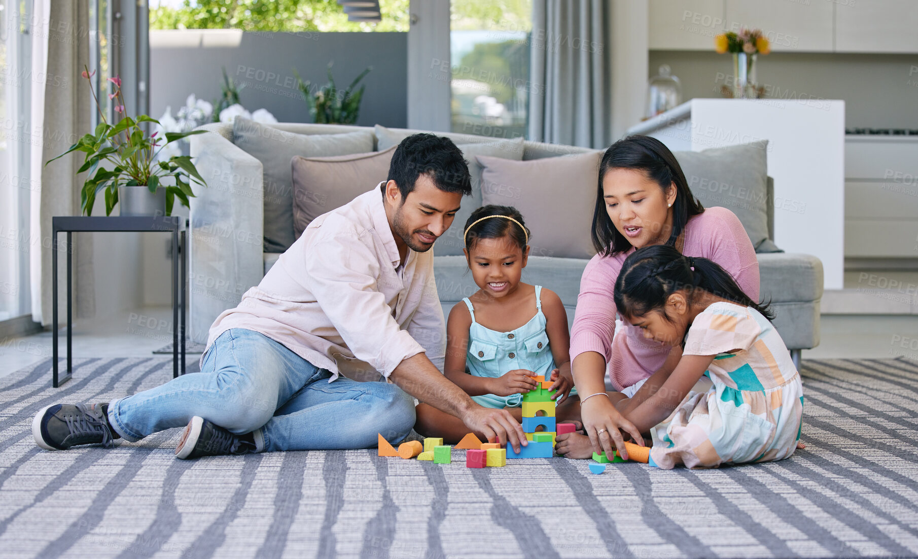 Buy stock photo Mother, father and children playing with building blocks in home on living room carpet, support or bonding. Man, woman and daughter for family connection with development games, education or learning