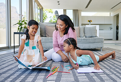 Buy stock photo Shot two sisters drawing together while their mother looks on