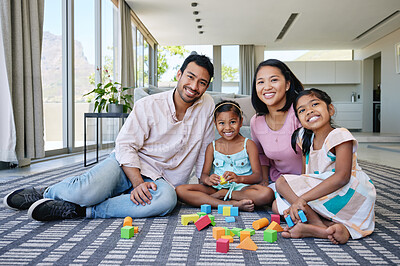 Buy stock photo Shot of a young couple playing with their daughters