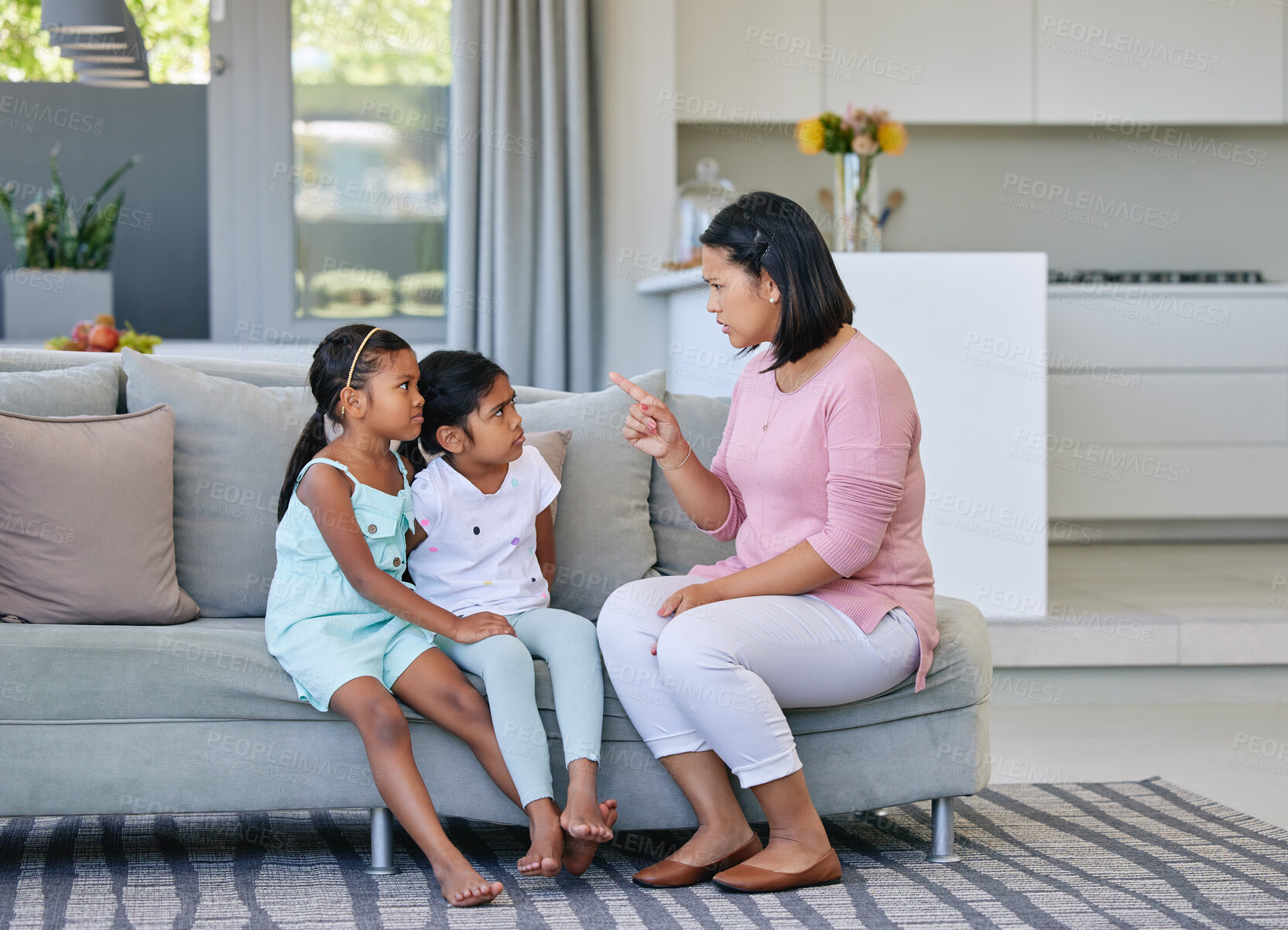 Buy stock photo Mother, pointing and angry children in home, discipline and communication or strict parent in family house. Living room, girl and sofa for punishment or conflict and behaviour, upset and parenting