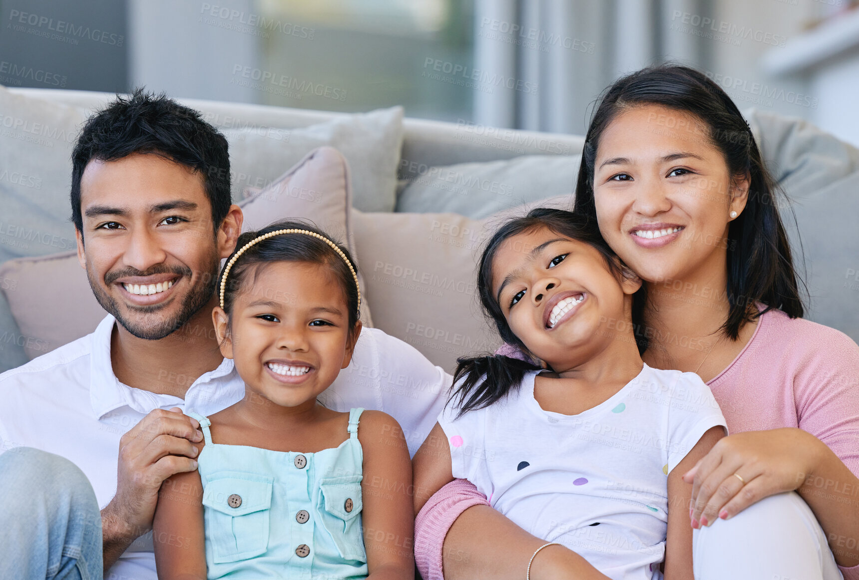 Buy stock photo Smile, happiness and portrait of family on sofa in living room for care, love and bonding together in home. Embrace, parents and girl children on couch for relax, having fun or weekend break in house