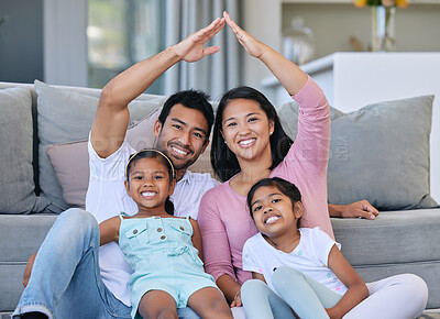 Buy stock photo Hand roof, portrait and family in a house for safety, security and investment. Happy, love and parents and children with hands to cover for family insurance, mortgage or property on the lounge floor