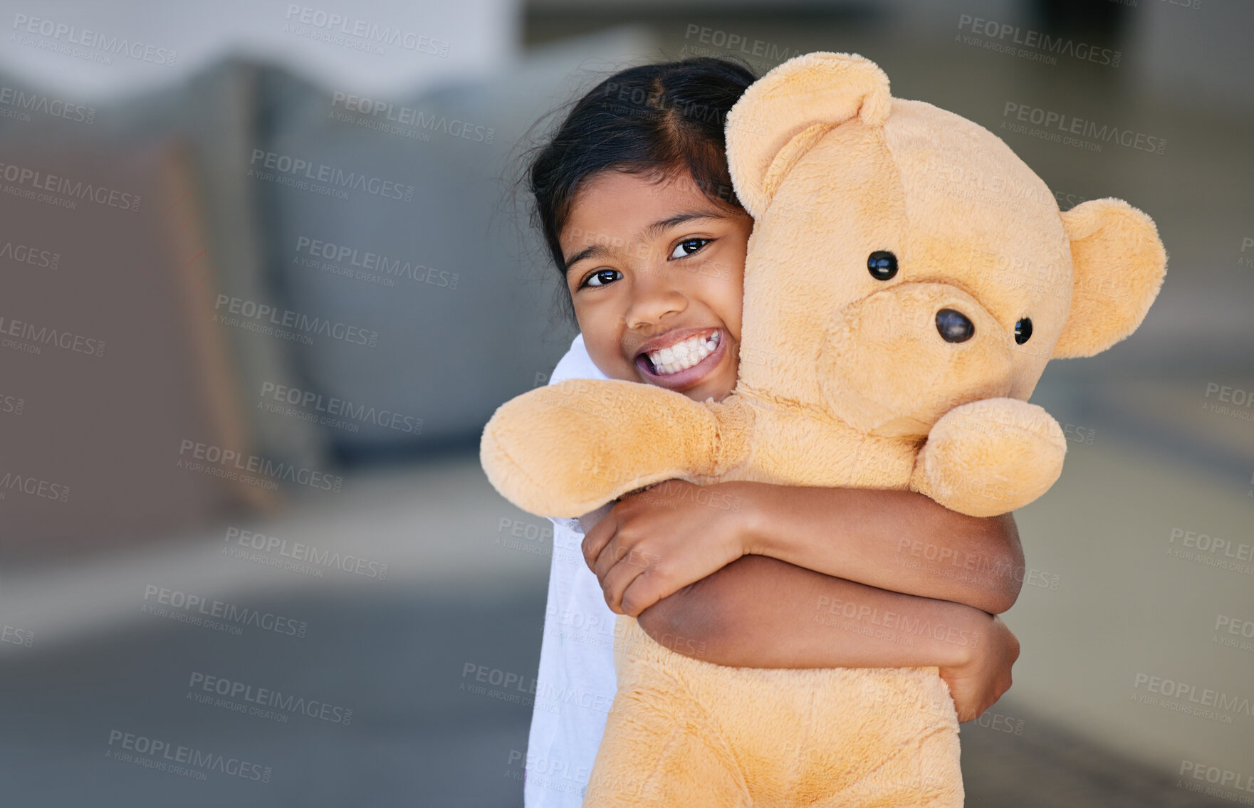 Buy stock photo Child, girl and teddy bear with hug in home, having fun and bonding with stuffed toy gift. Support, care and love of childhood playing with kid portrait and smile with sofa in house living room