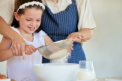 Buy stock photo Shot of a little girl helping her parent cook in the kitchen at home