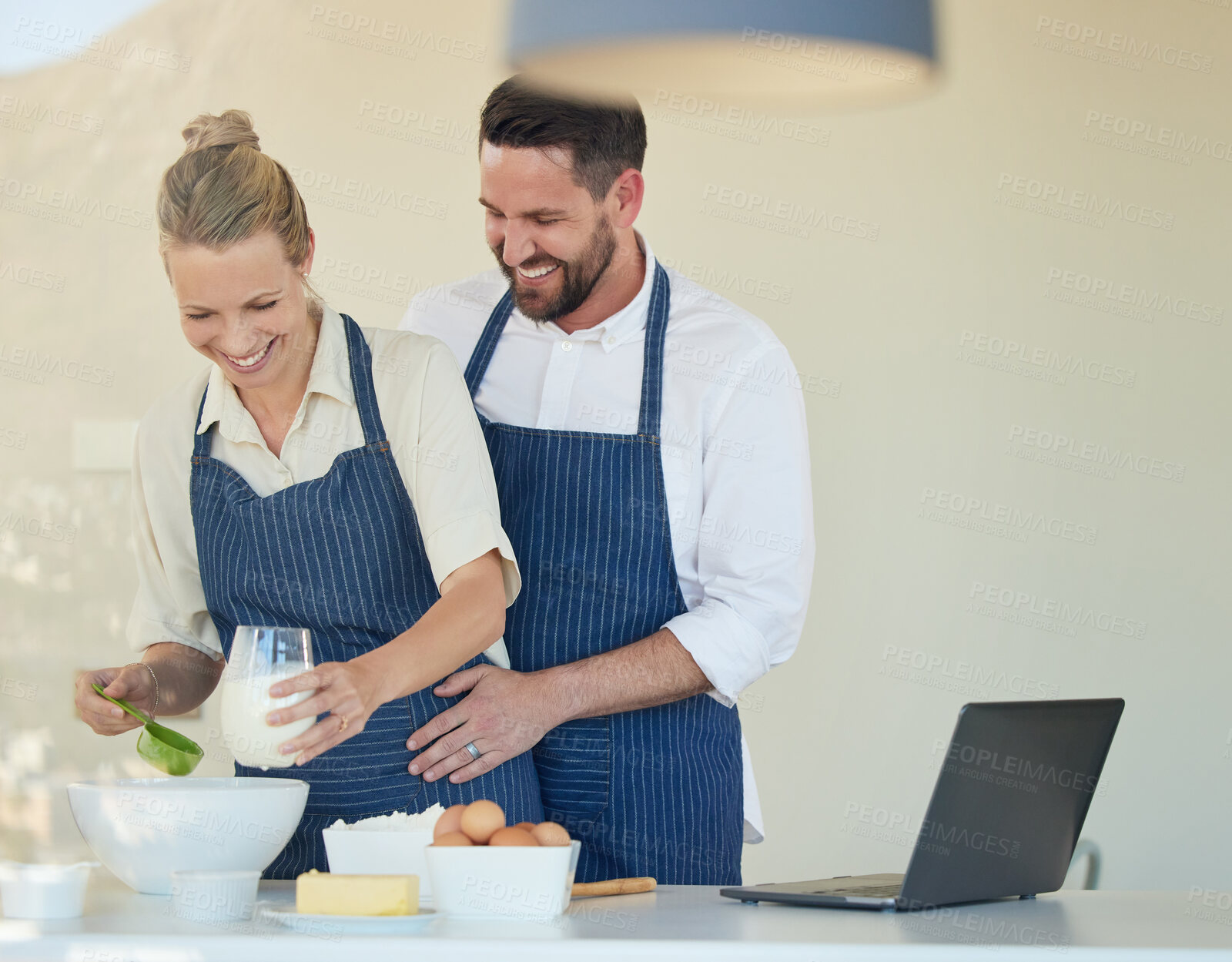 Buy stock photo Couple, hug and baking in kitchen of home with laptop for learning recipe together on vacation. Happy, chef and partner cooking with support, help and love in marriage with meal prep or food 