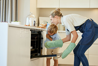 Buy stock photo Shot of a young mother and son cooking together at home
