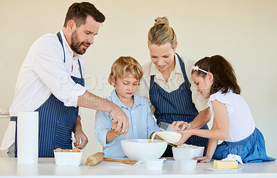 Buy stock photo Shot of a young family cooking together at home