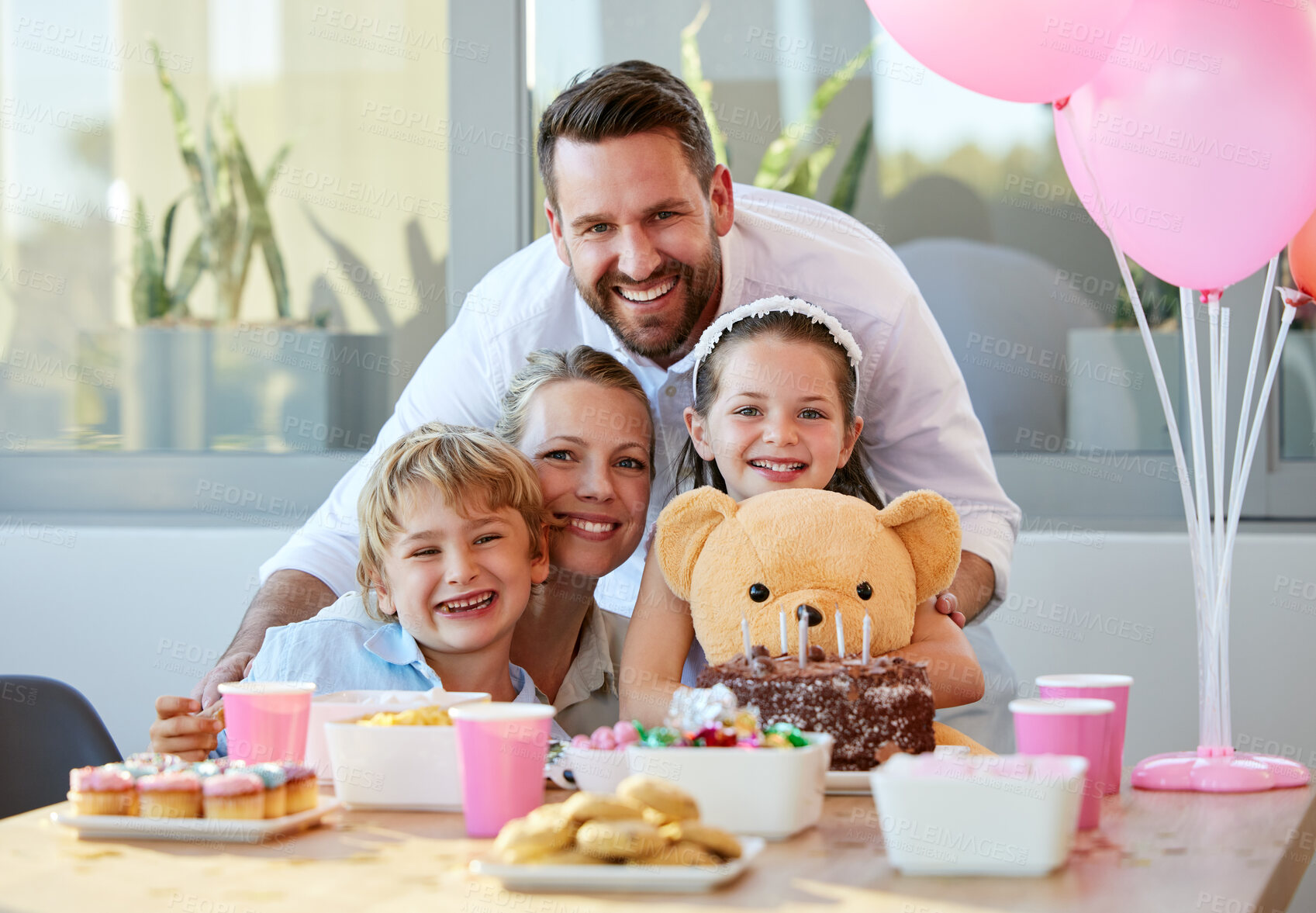 Buy stock photo Parents, children and birthday cake for celebration with candles, love and sweets at home. Happiness, mother and father together at table with happy kids, party and balloons at event at house