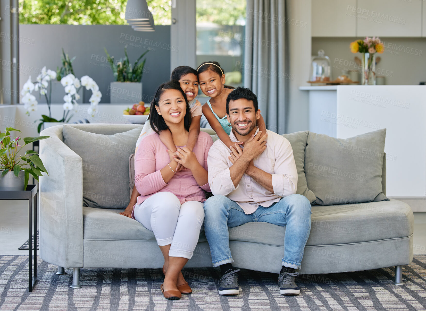 Buy stock photo Hug, happiness and portrait of family on sofa in living room for care, love and bonding together in home. Smile, parents and girl children on couch for relax, having fun or weekend break in house