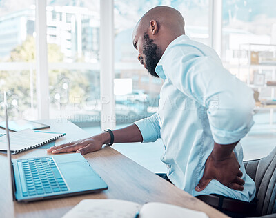 Buy stock photo Businessman, laptop and pain in back in office for tired with muscle injury, job stress and poor posture. Black male consultant, tech and body fatigue by desk with spine problem, strain and scoliosis