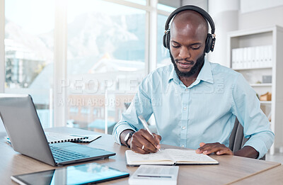 Buy stock photo Headphones, writing and black businessman in office, workspace or professional space for work in corporate career. Productivity, employee and laptop or notebook for planning, agenda and communication