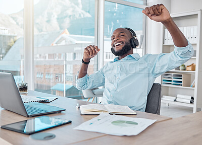 Buy stock photo Happy black man at desk with headphones, music and enjoying work with excited dance at desk with tech. African businessman in modern office with earphones, dancing and fun working on startup report.