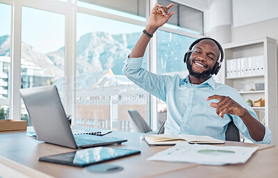 Buy stock photo Dance, happy man at desk with headphones, music and enjoying work with online radio streaming service. African businessman in modern office with earphones, dancing and fun working on startup report.