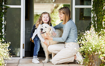 Buy stock photo Shot of a mother and daughter bonding with their dog in the backyard at home