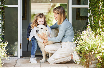 Buy stock photo Shot of a mother and daughter bonding with their dog in the backyard at home